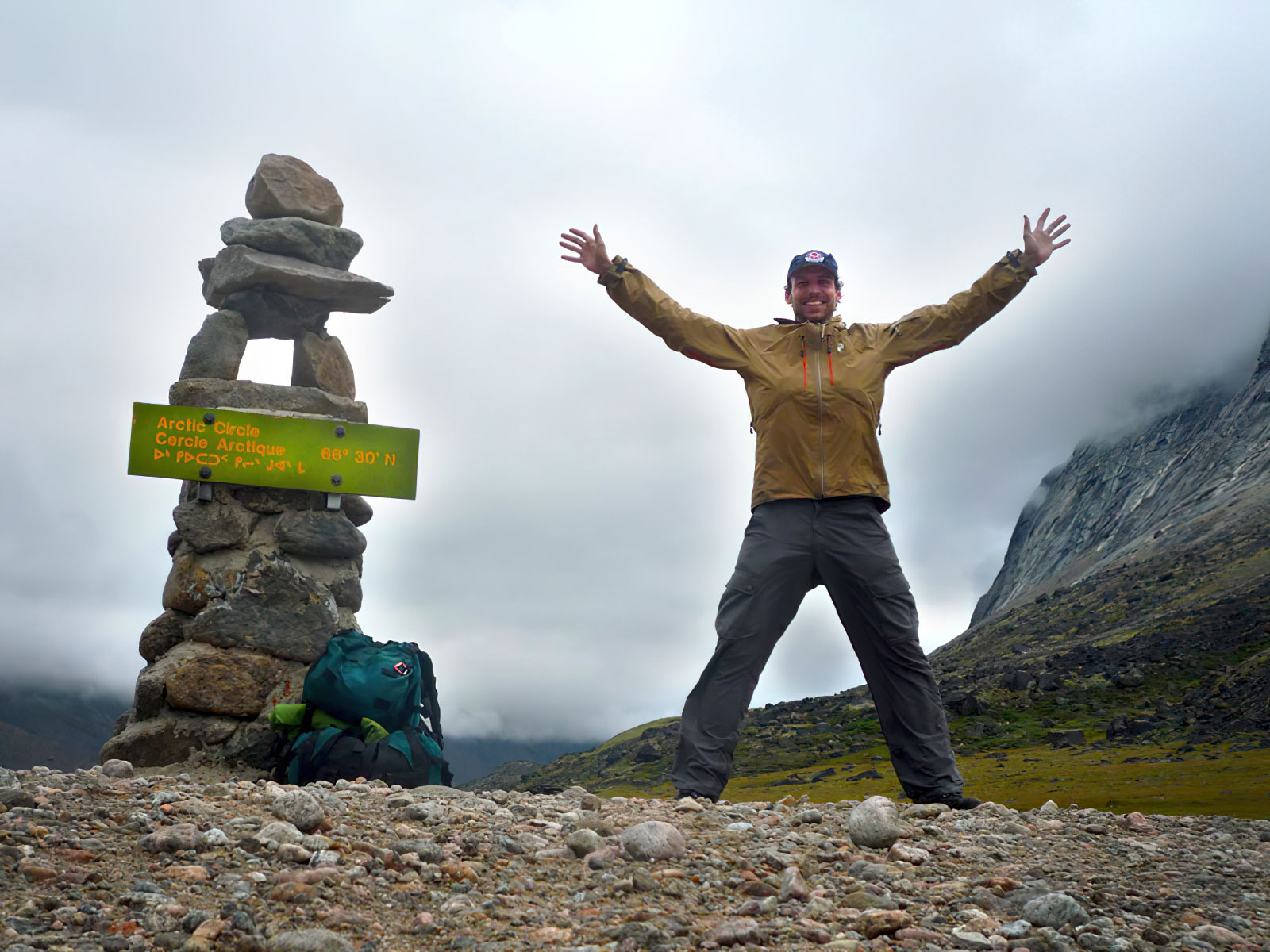 Person celebrating near rock formation