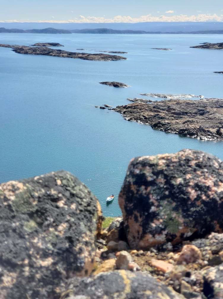 Rocky shoreline with distant boat