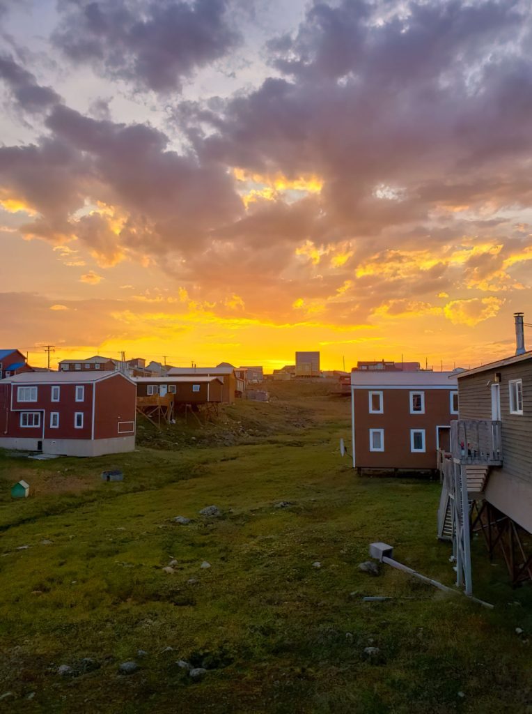Colorful sunset over wooden houses