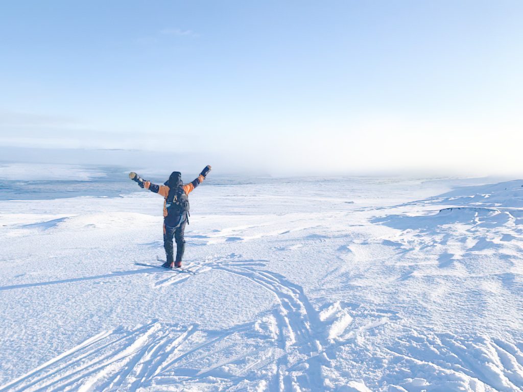 Person celebrating in snowy landscape
