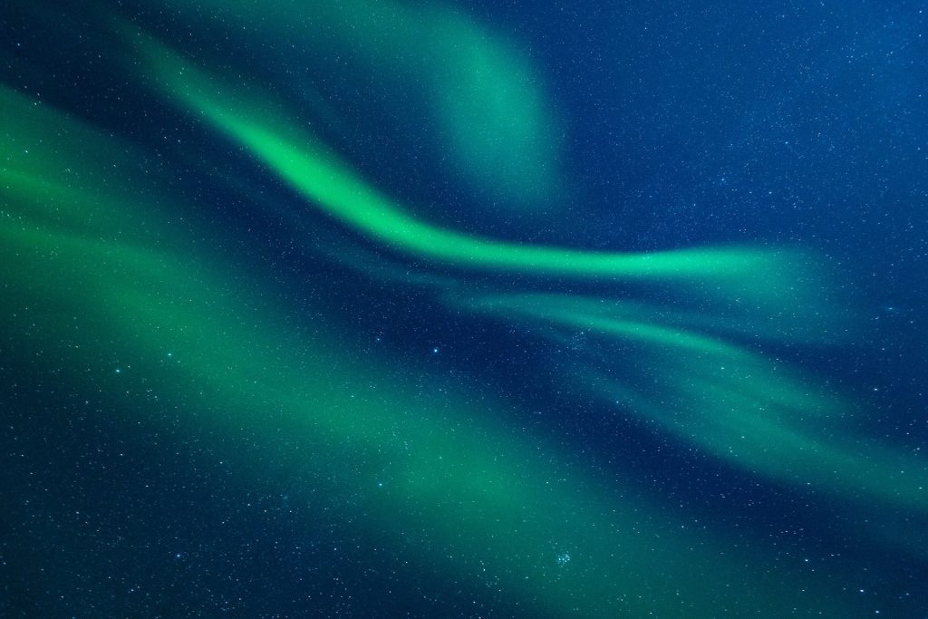 Vibrant green auroras in night sky