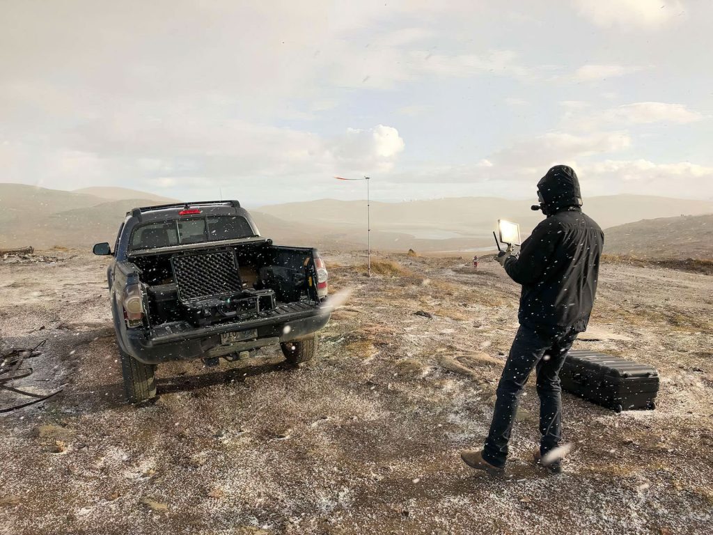Person standing near truck in snow
