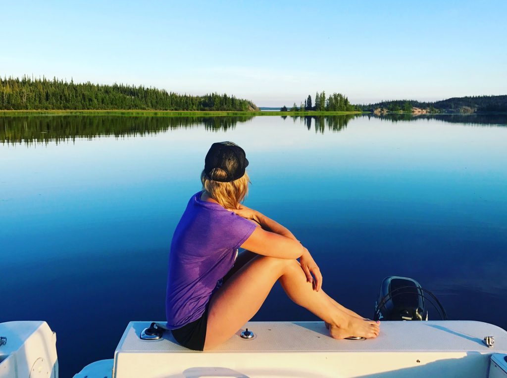 Person sitting on boat by lake