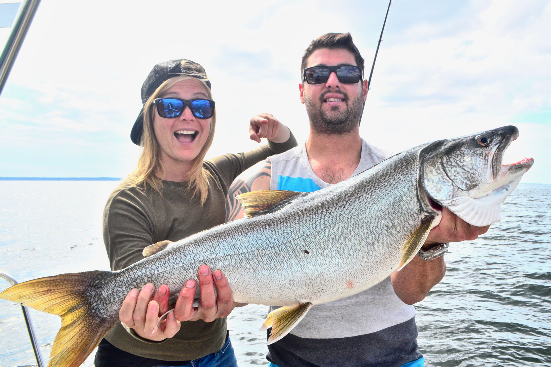 Two people holding a large fish