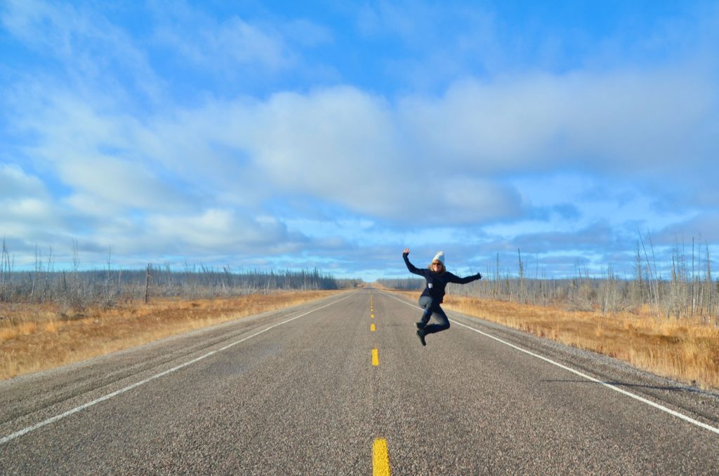 Person jumping on empty road