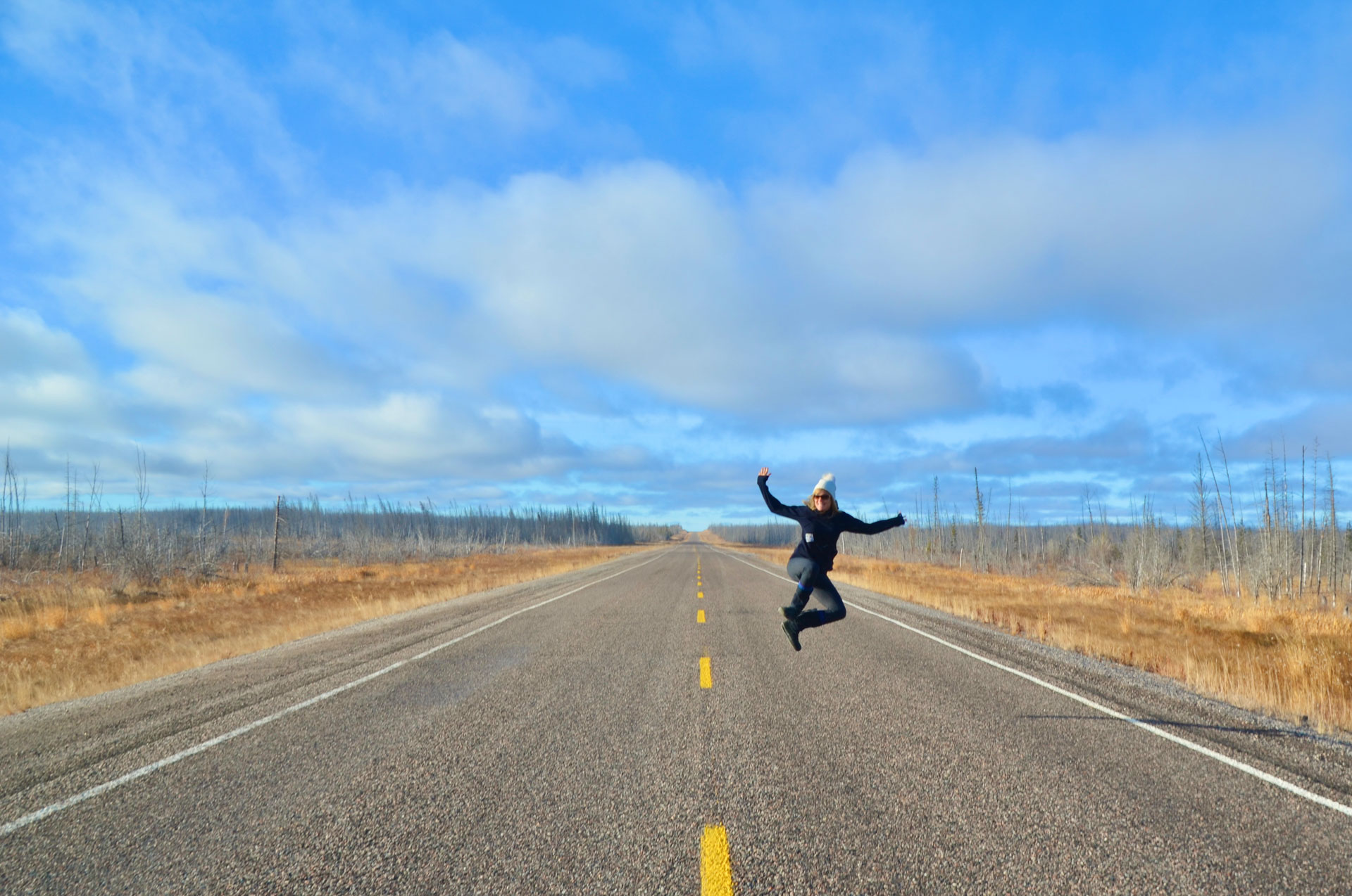 Person jumping on empty road