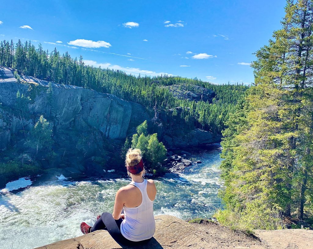 Person sitting by a river