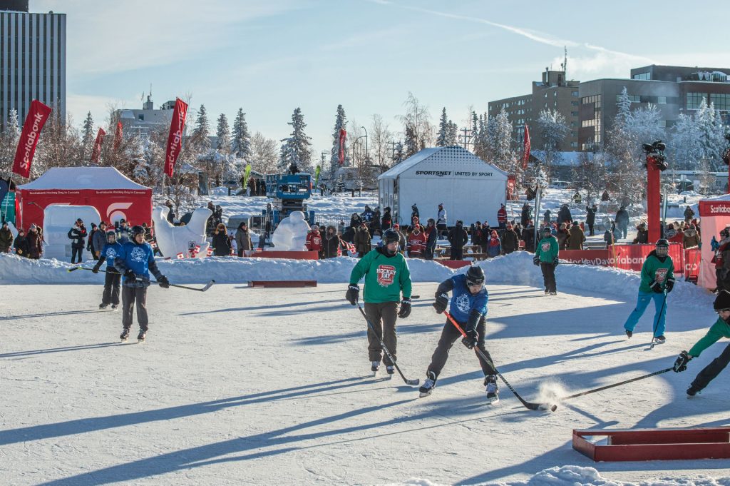 People playing hockey on outdoor rink