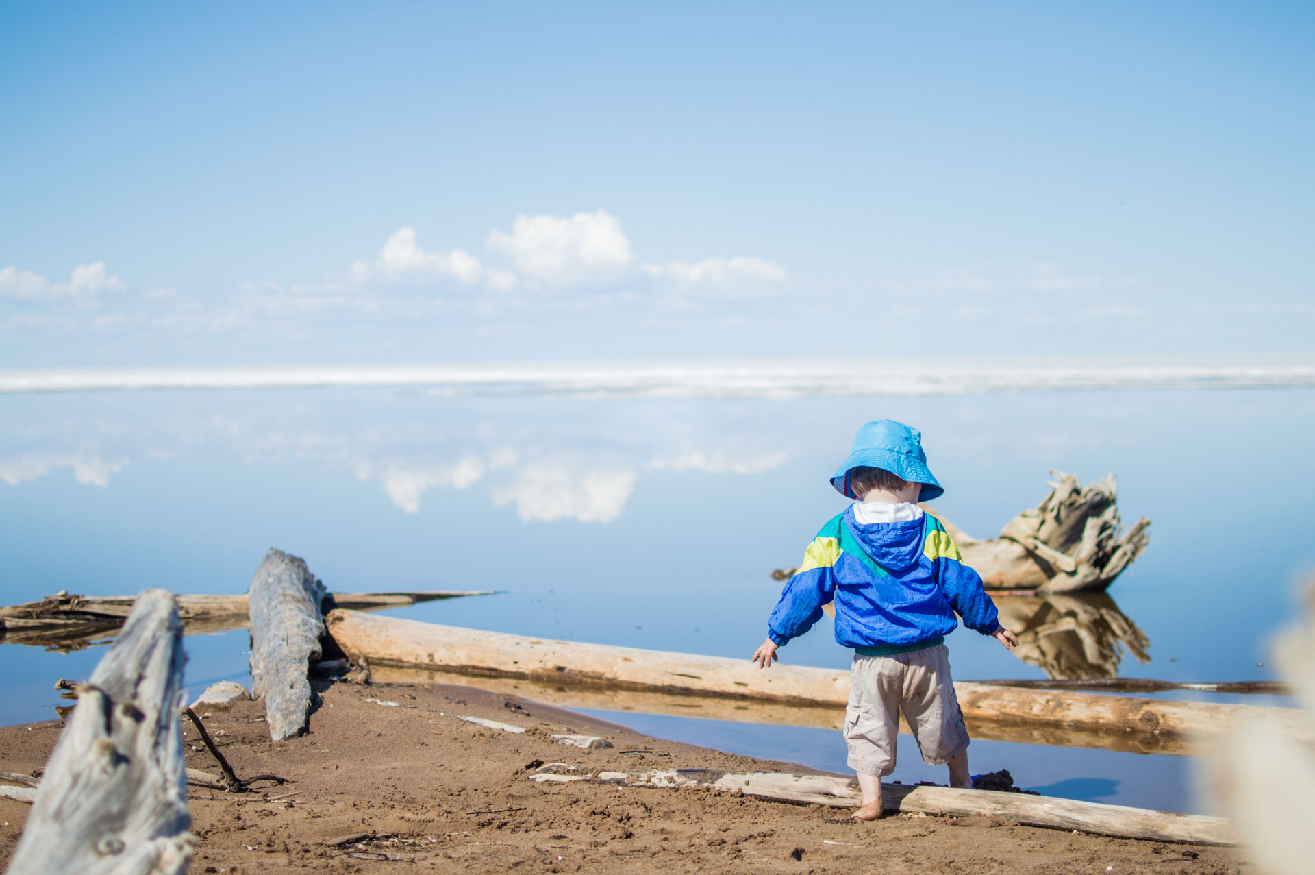 Child exploring a serene beach scene.