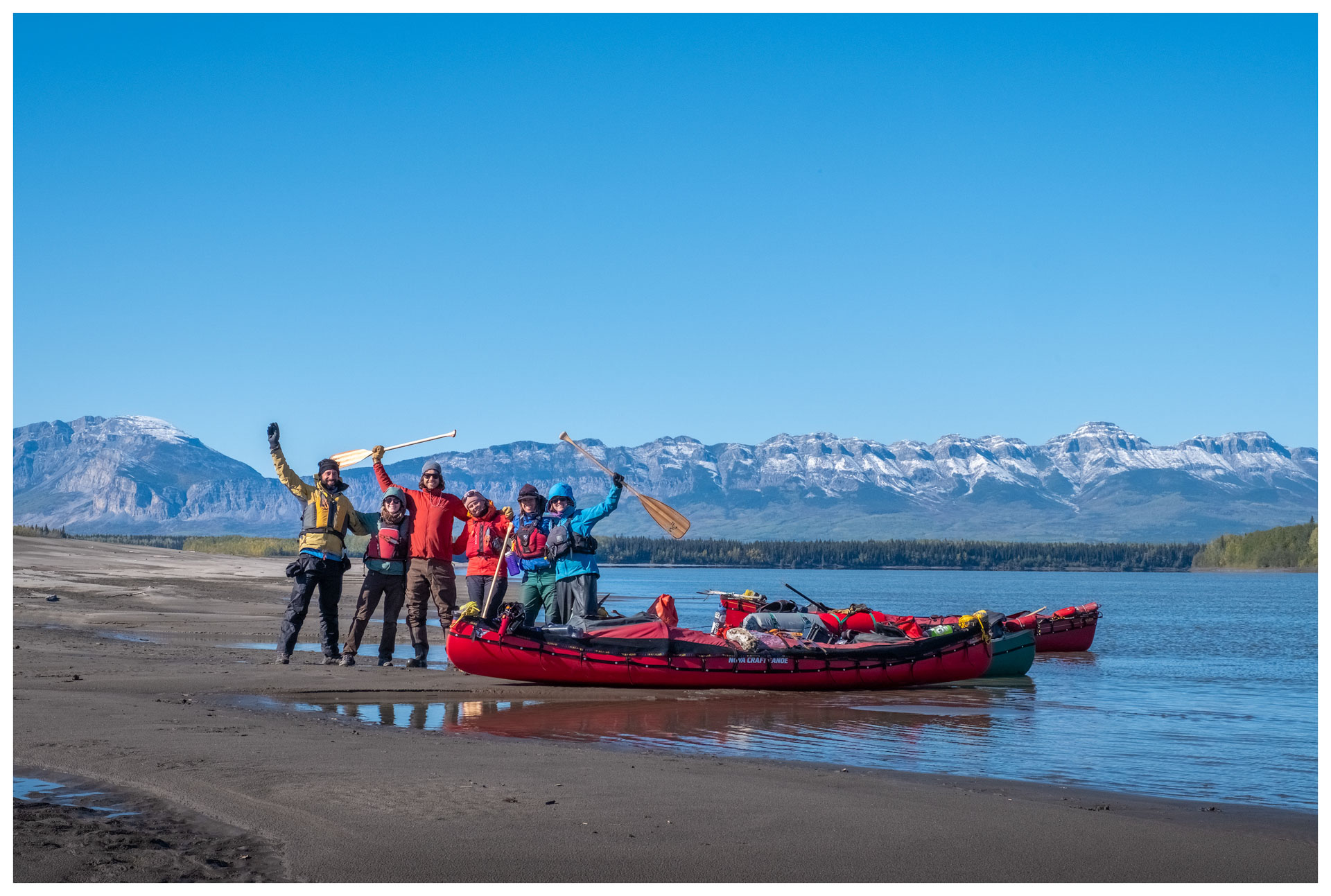 Group of kayakers on riverbank