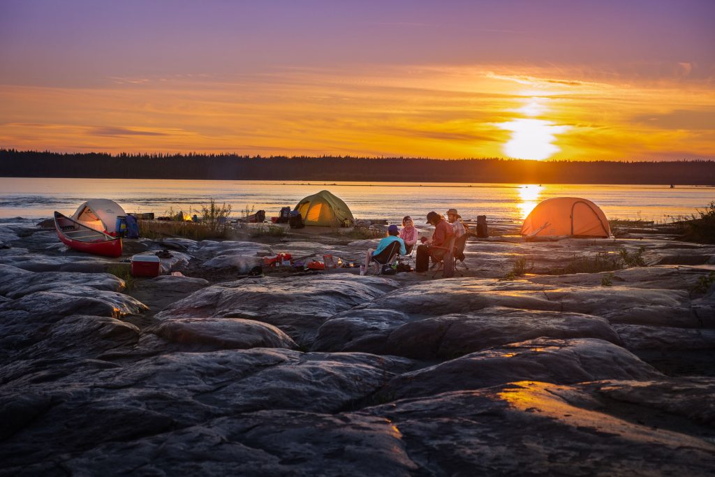 Camping by the river at sunset
