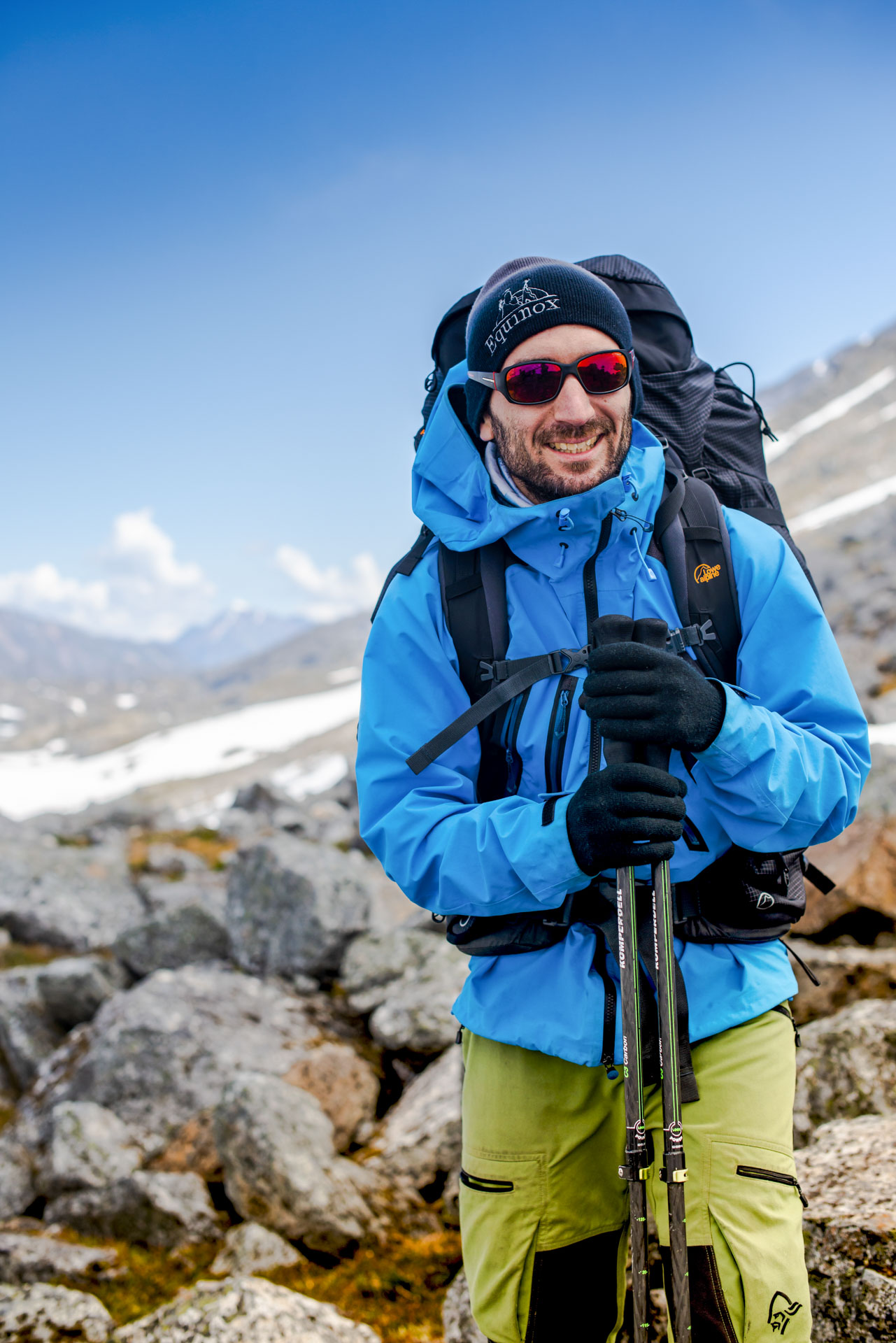 Hiker in blue jacket on rocks