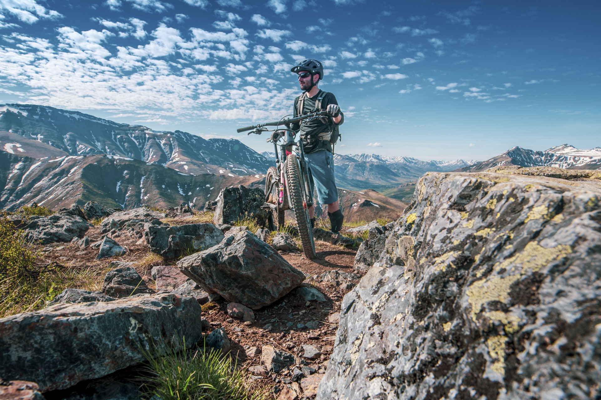 Mountain biker on rocky landscape.