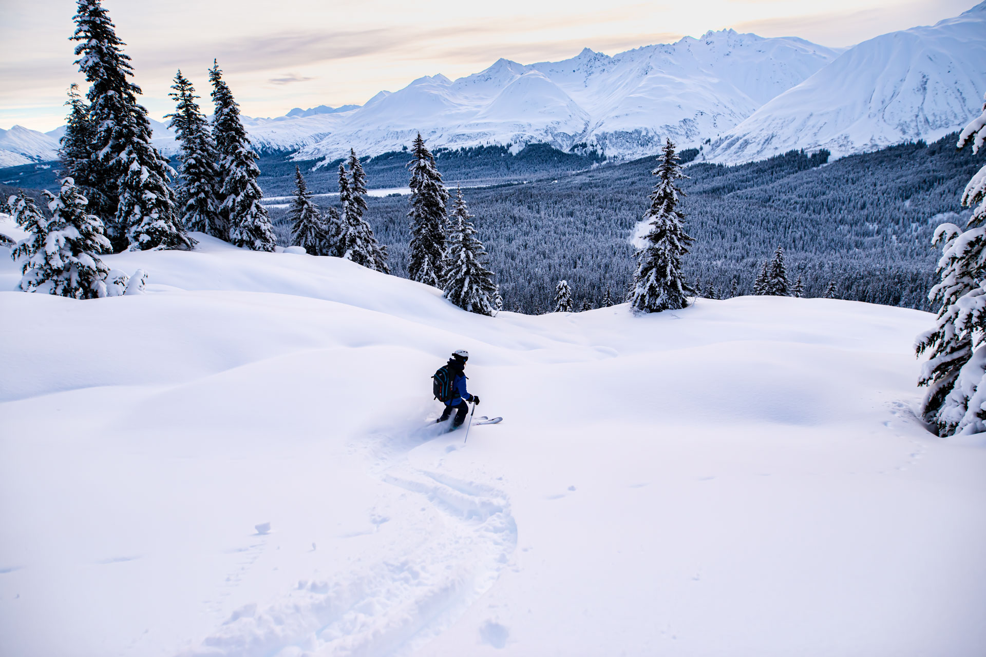 Snow-covered landscape with lone hiker