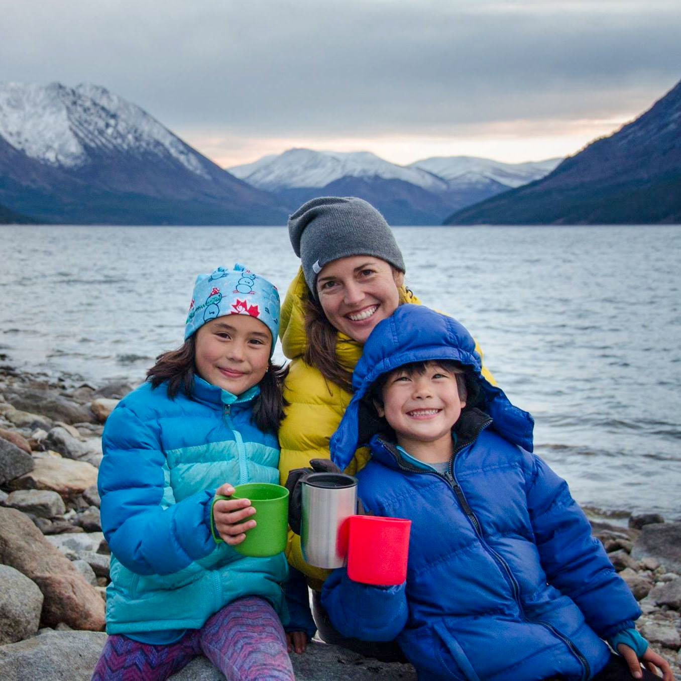 Family enjoying drinks by lake