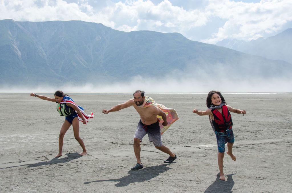 Family playing on sandy landscape