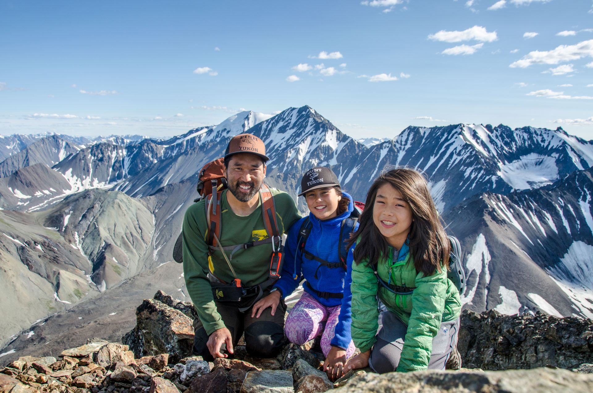 Family enjoying mountain summit view.