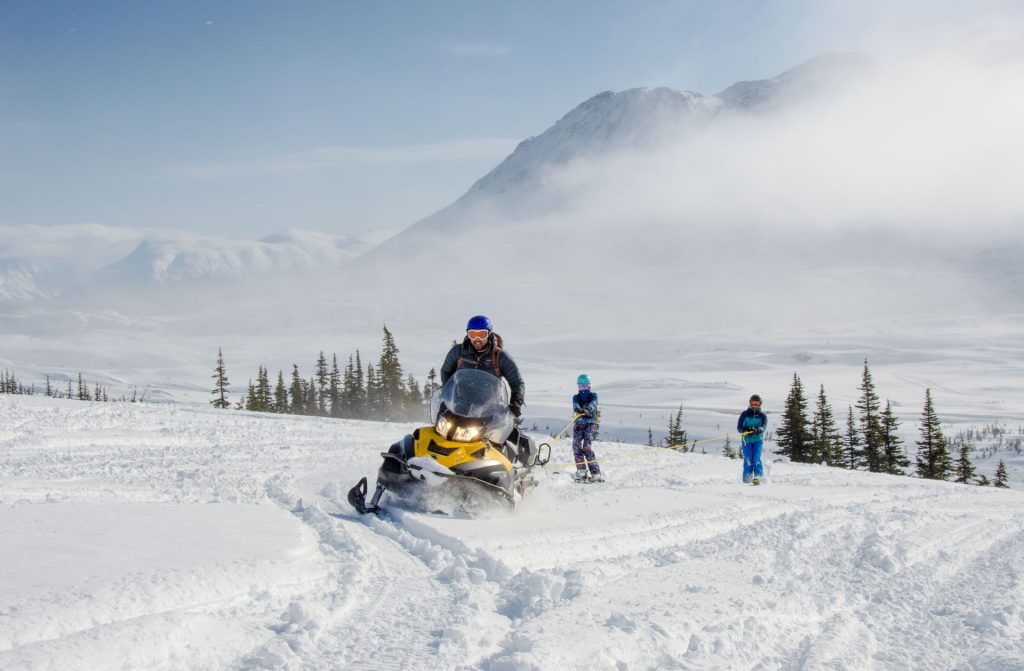 Snowmobiles in snowy mountainous landscape