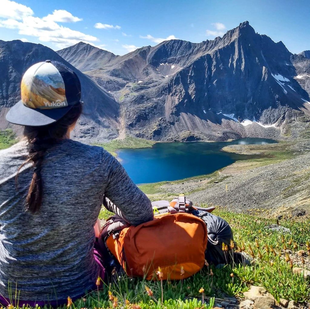 Person overlooking a scenic mountain lake.