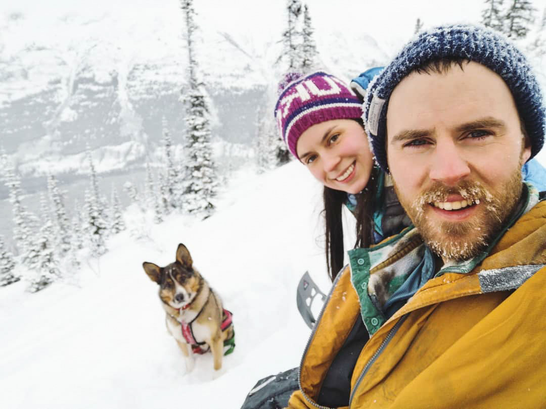 Couple and dog in snowy landscape