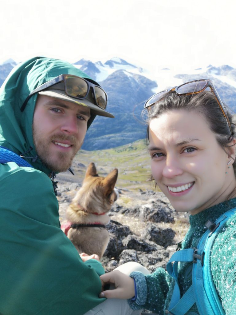 Couple with dog in mountainous landscape