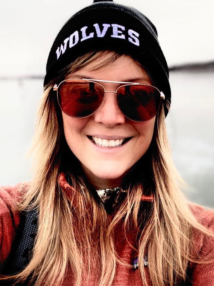 Smiling woman in sunglasses and beanie