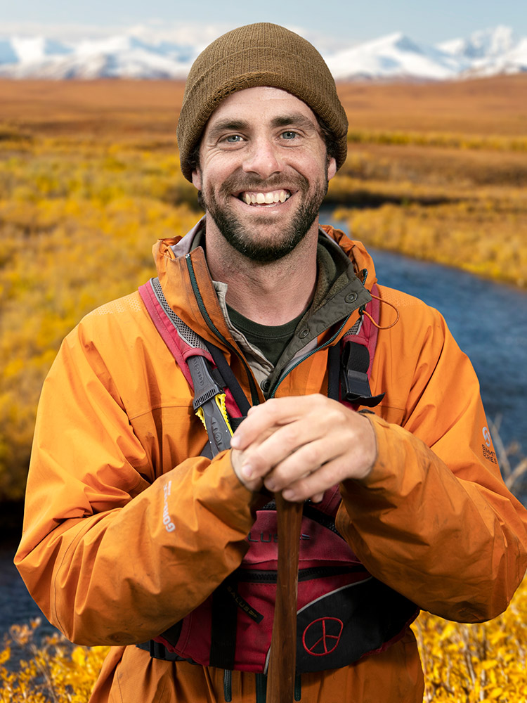 Smiling man in orange jacket outdoors