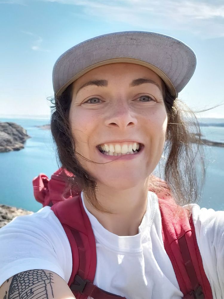 Smiling person on a scenic hike.