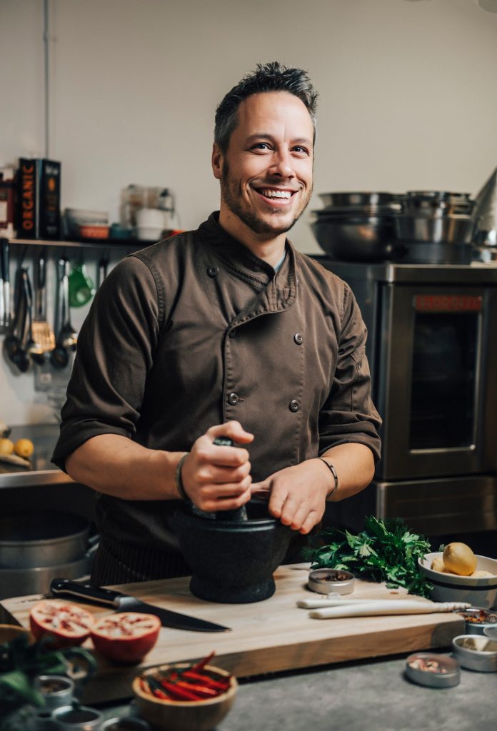 Smiling chef preparing ingredients in kitchen