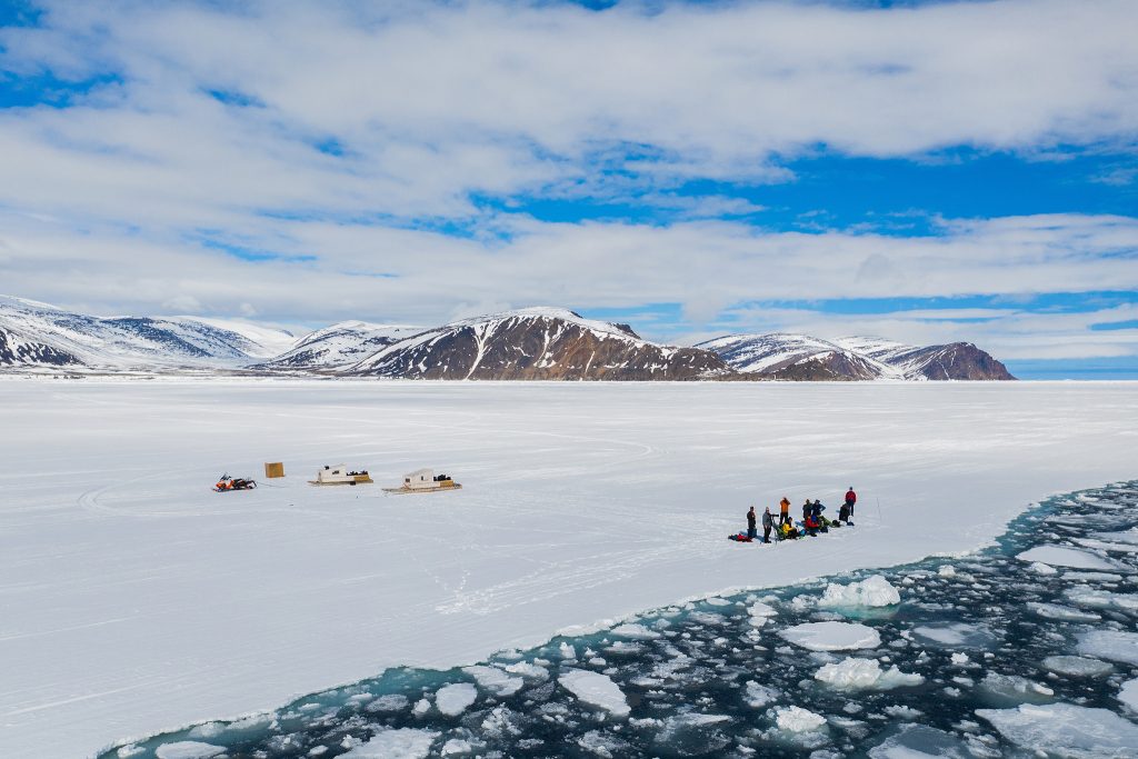 Snowy landscape with people and tents