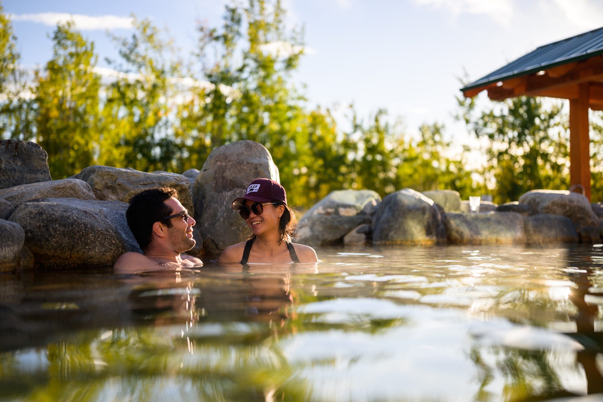 Couple relaxing in natural hot springs.