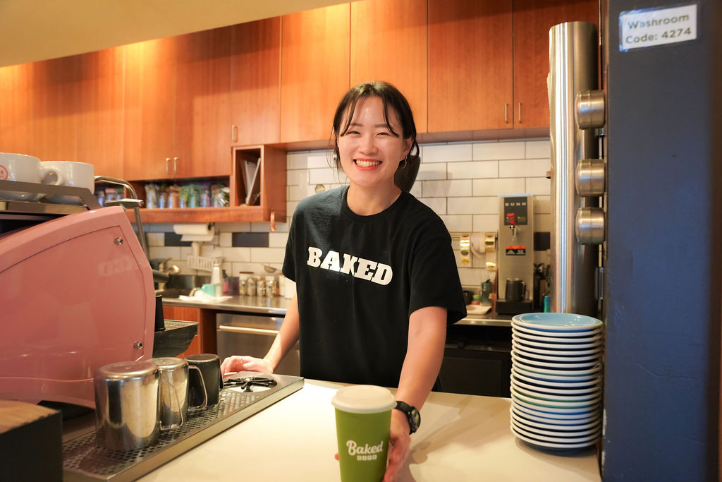 Smiling barista serving coffee
